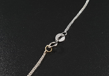 Cargar imagen en el visor de la galería, Croce in oro bianco 18k con diamanti bianchi e neri