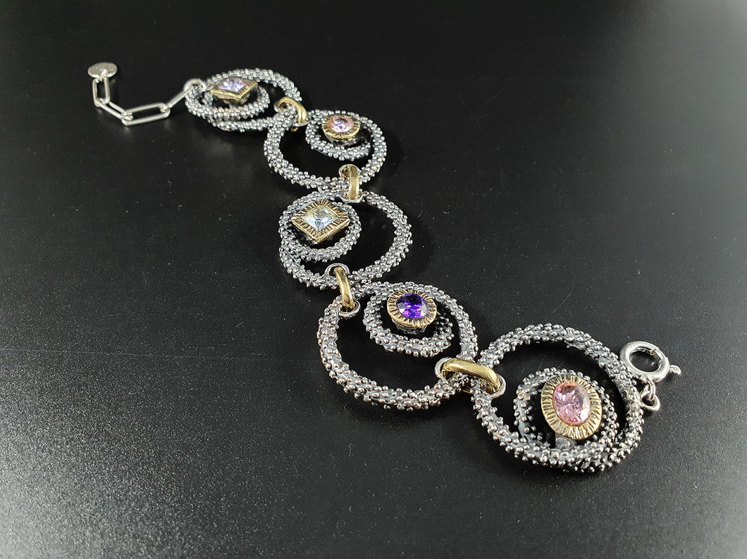 Bracciale in argento e bronzo con grandi zirconi colorati